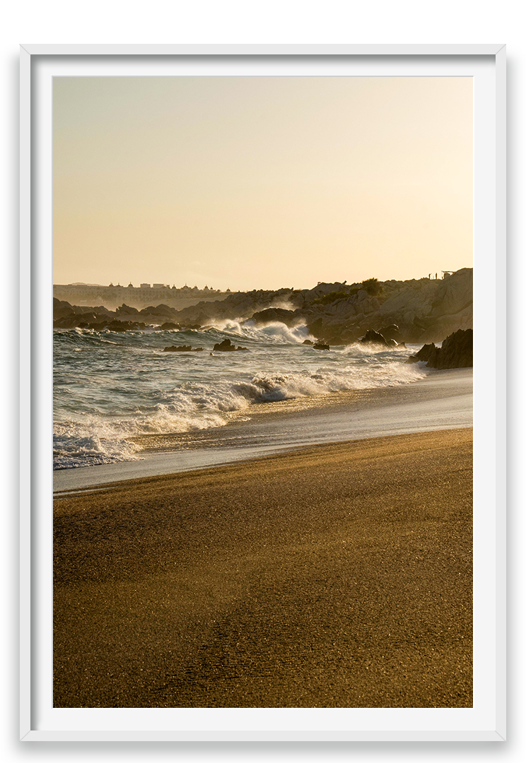 Waves crashing on sand, golden hour