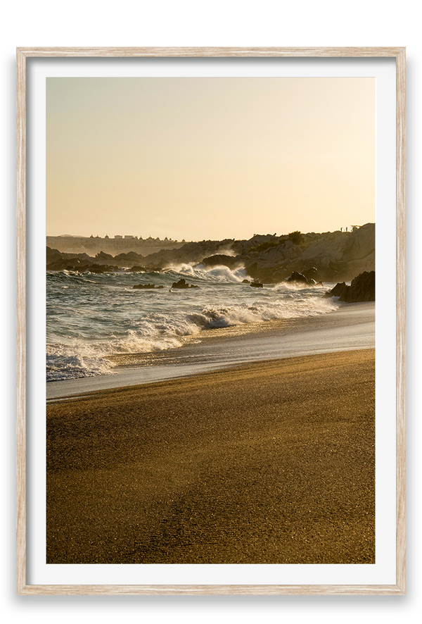 Waves crashing on sand, golden hour