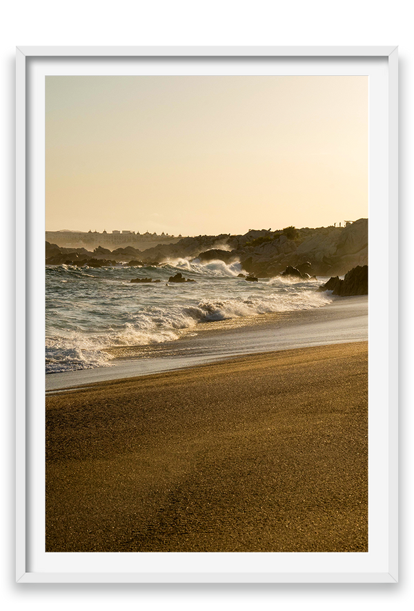 Waves crashing on sand, golden hour