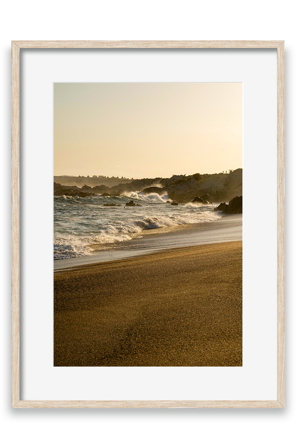 Waves crashing on sand, golden hour