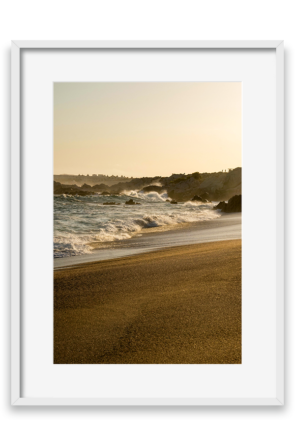 Waves crashing on sand, golden hour