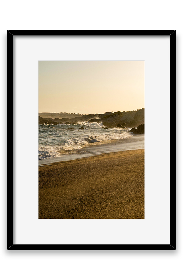 Waves crashing on sand, golden hour