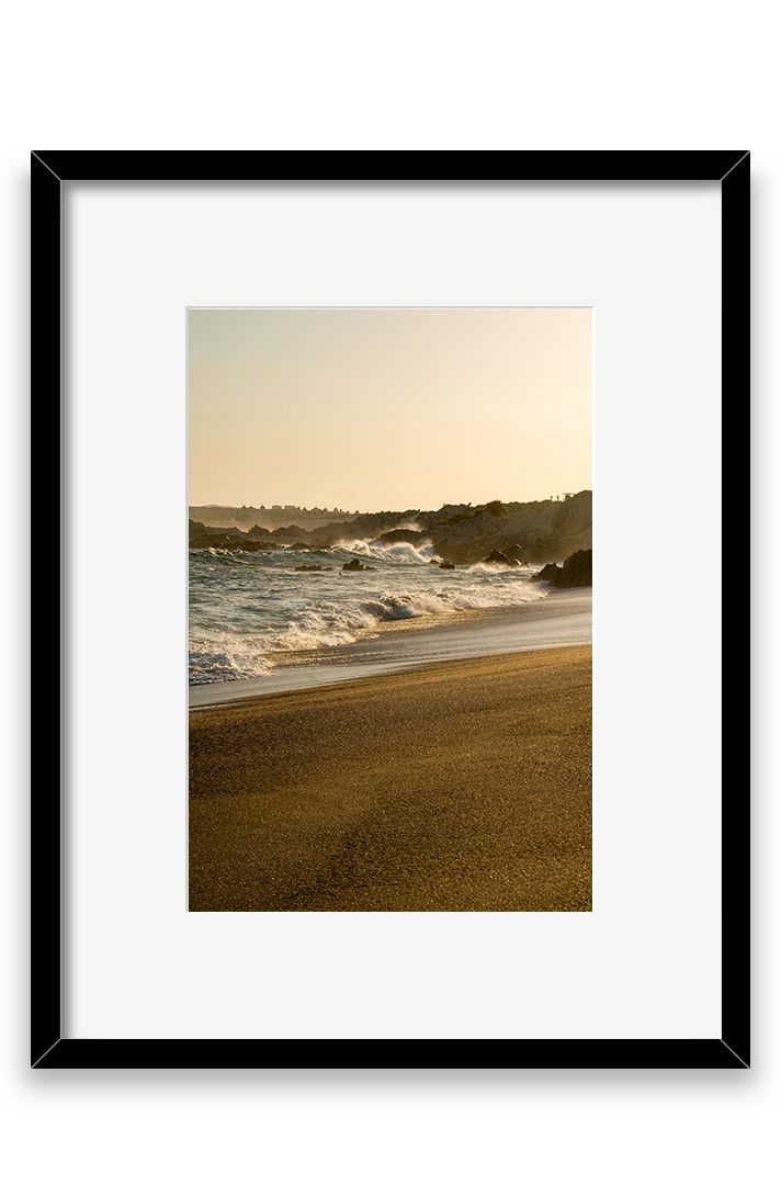 Waves crashing on sand, golden hour